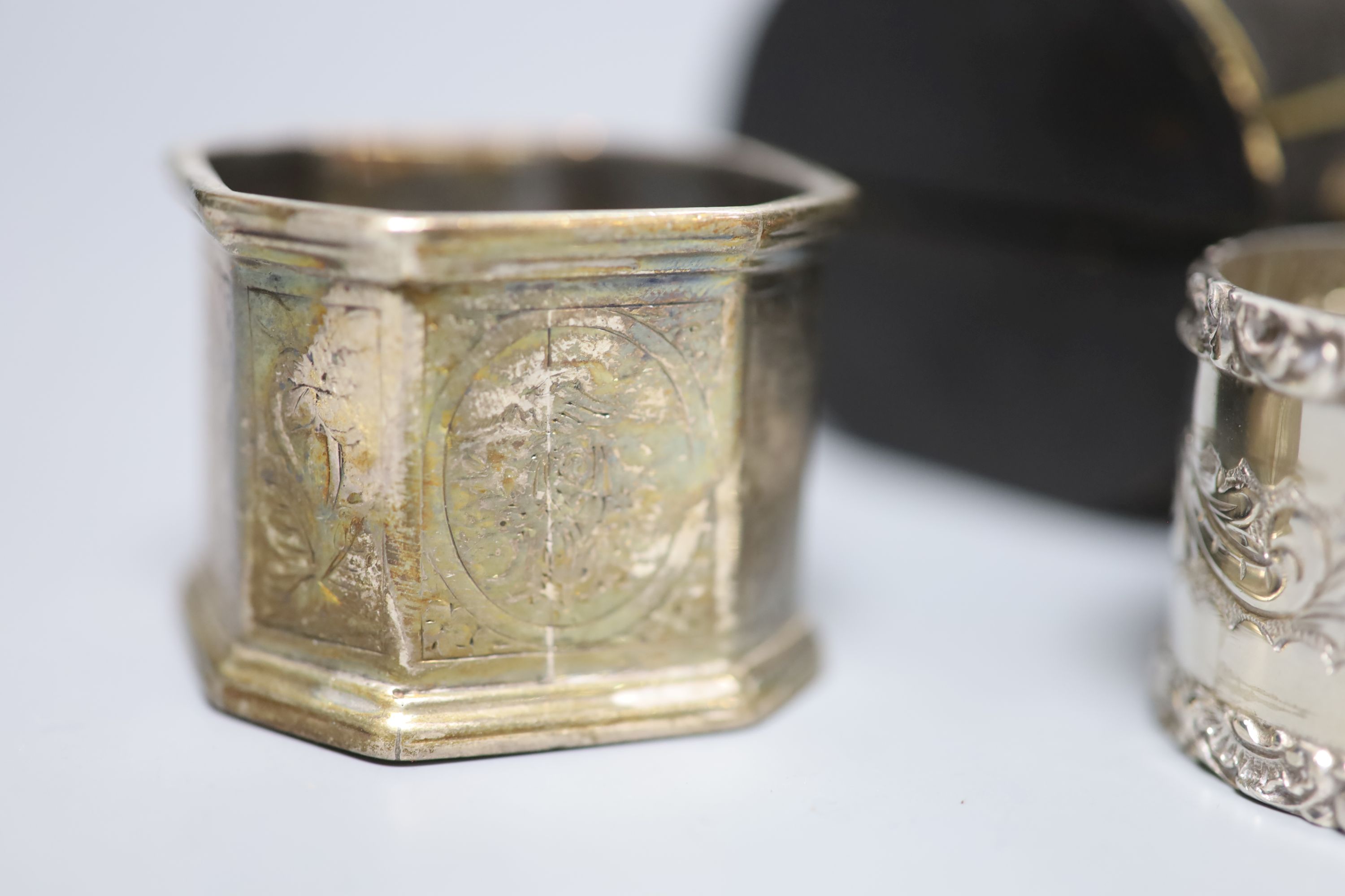 A cased late Victorian silver napkin ring, one other similar pair and a later silver napkin ring